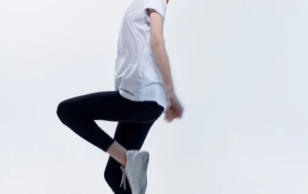 Woman in sportswear and sneakers on a light background fitness gymnastics — Stock Photo, Image