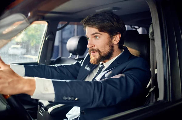 rich man in suit driving a car trip fun lifestyle