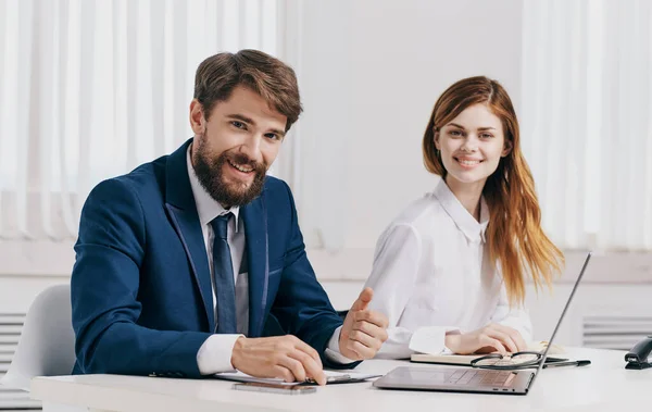 Business man and woman in shirt with laptop at the table in the office staff office