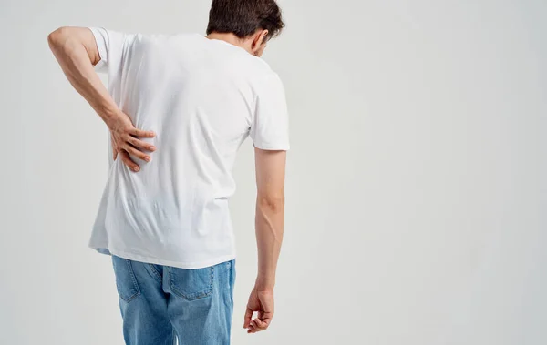 Homem em t-shirt branca dor nas costas osteocondrose do modelo da coluna vertebral visão traseira — Fotografia de Stock