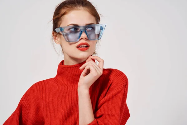 Emotional woman with blue glasses on her face bright makeup red sweater — Stock Photo, Image