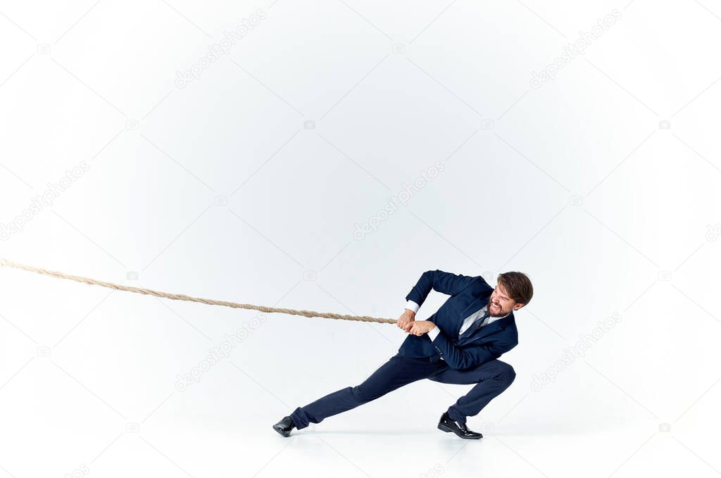 man with rope in hand on light background business finance advertising model