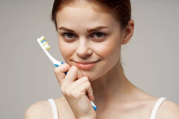 pretty woman toothbrush dental care and his health in the morning