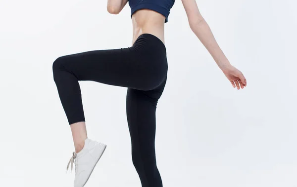 Woman in black leggings cropped view Copy Space light background sport fitness — Stock Photo, Image