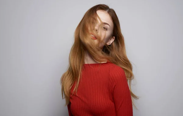 Beautiful woman in red sweater bright makeup gray background cropped view — Stock Photo, Image