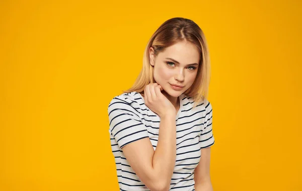 Woman in striped t-shirt cropped view of yellow background — Stock Photo, Image