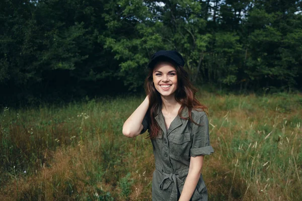 woman in the forest Cheerful smile black cap fresh air freedom green leaves