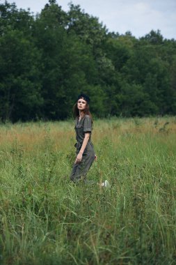 Doğadaki kadın yürüyen yeşil tulum temiz hava 