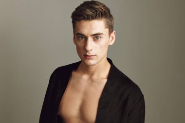 Yakışıklı, düğmeleri açık, siyah gömlekli şık saç stili. Yaklaş.