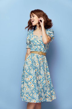 Elbiseli kadın. Ağzı açık, eğlenceli. Manzaralı saç stili. 