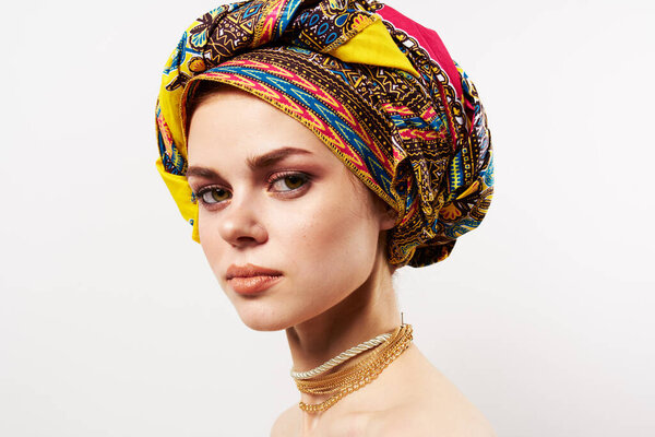 pretty woman in multicolored turban decoration close-up