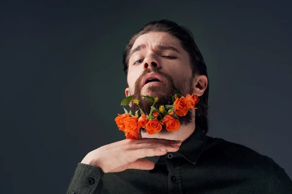 Emotional  man with  flowers in beard. High quality photo