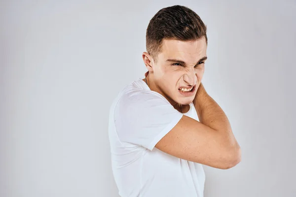Man in white t-shirt displeased facial expression gesturing with hands studio lifestyle Royalty Free Stock Images