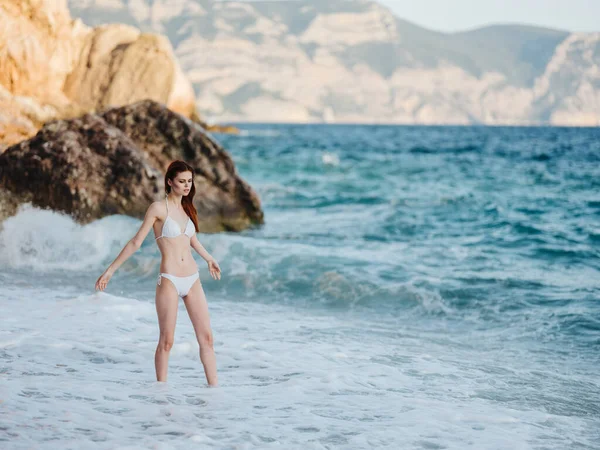 Bella donna in costume da bagno sulla spiaggia e acqua limpida di rocce oceaniche turismo di viaggio — Foto Stock