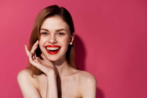 Nette fröhliche Frau und rote Lippen Kosmetik Emotionen rosa Hintergrund — Stockfoto