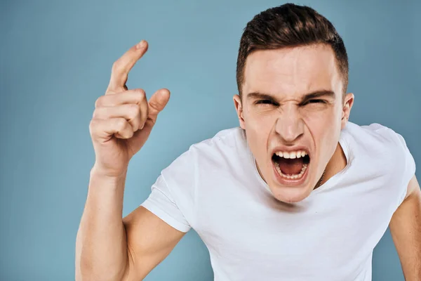 Man gestures with his hands emotions white t-shirt expression blue background — Stock Photo, Image