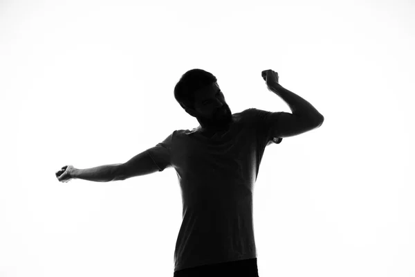Schwarze Silhouette eines Mannes, der mit den Händen auf hellem Hintergrund gestikuliert — Stockfoto
