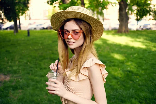 Pretty woman in hat walk outdoors in summer park leisure — Stock Photo, Image