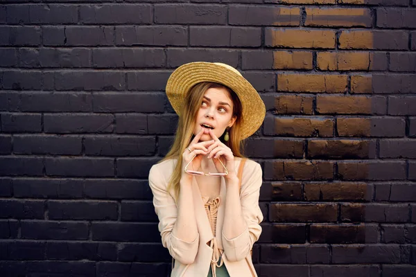 Elegant woman in hat walking fresh air brick black wall — Stock Photo, Image