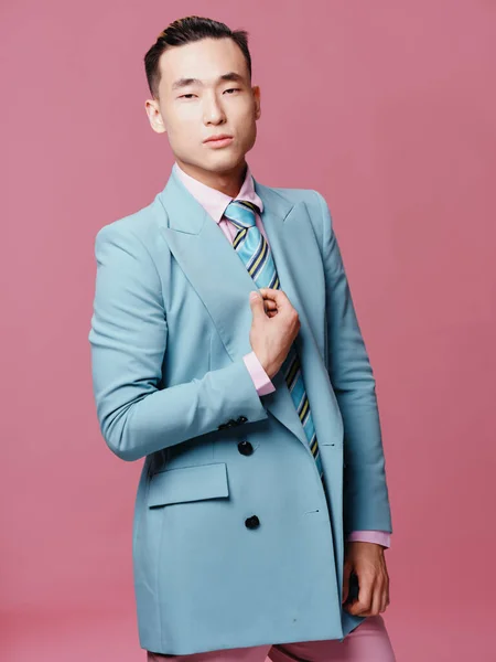 Man of Asian appearance elegant style tie official fashion pink background — Stock Photo, Image