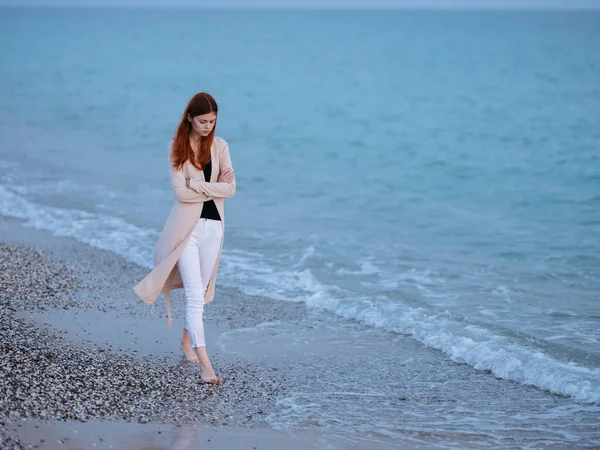 Woman on the beach near the ocean transparent water sweater model — Stock Photo, Image