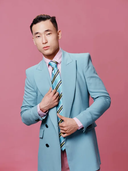 Male Asian appearance suit official elegant style pink background model — Stock Photo, Image