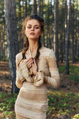 Elbise ve saç stili kozalaklı ağaçlar içinde rüya gibi bir kadın.