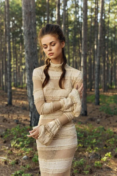 Charming lady in a dress in the woods on nature hairstyle model romance
