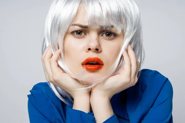 Pretty woman holding hands near face white wig red lips close-up blue shirt — Stock Photo, Image
