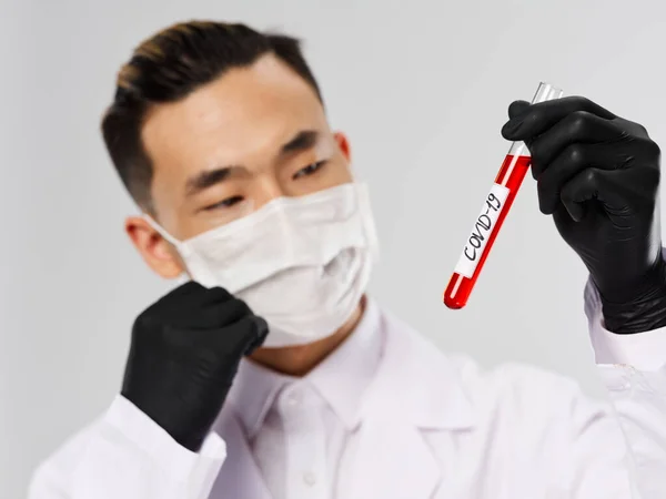 Asiatico uomo sangue test diagnostics guanti neri primo piano — Foto Stock