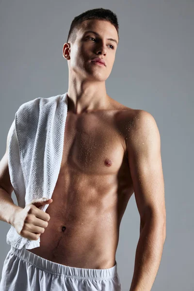 Cute guy with pumped up body posing white towel studio — Stock Photo, Image