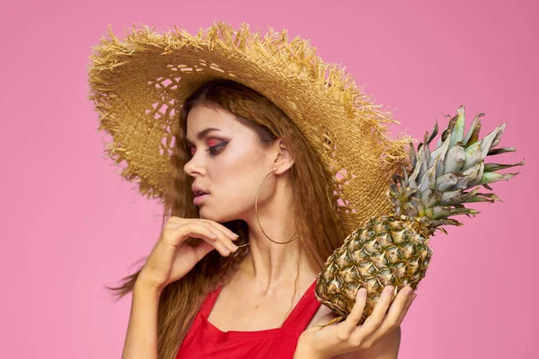 Kvinna i halm hatt på oss frukter kul kosmetika rosa bakgrund — Stockfoto