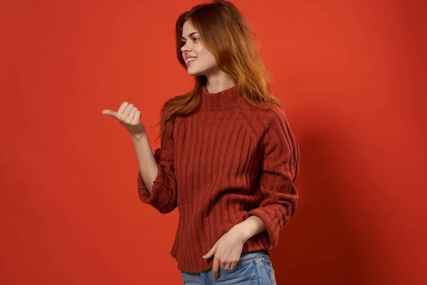 pretty woman red sweater gesture hands posing red background