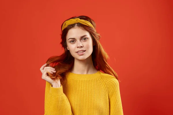노란 스웨터를 입고 빨간 배경을 가진 매우 감정적 인 여성 — 스톡 사진