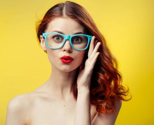 Attractive woman with bare shoulders blue glasses red hair cropped view — Stock Photo, Image