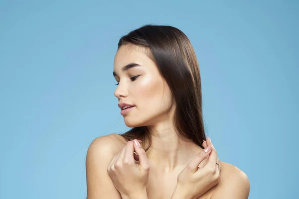 Woman with naked shoulders long hair cosmetics attractive look blue background — Stock Photo, Image