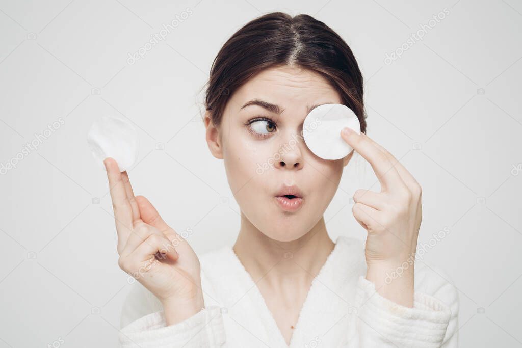 woman with a spoiler in front of the eye on a light background fun emotions