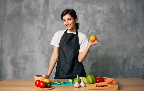 Femme cuisinier noir tablier tranchant légumes planche à découper cuisine cuisine cuisine nourriture — Photo