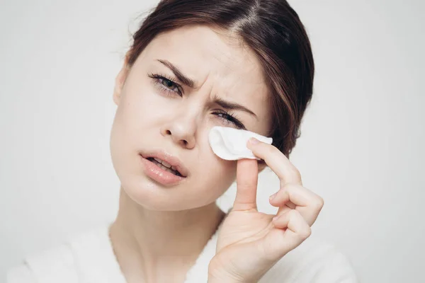 Huidverzorging vrouw veegt haar gezicht met witte spons — Stockfoto