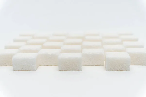 Sucre cubes échelonné bonbons ingrédient glucose lumière fond — Photo