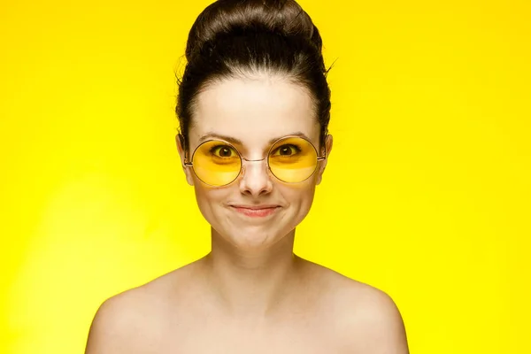 Attractive woman naked shoulders yellow glasses fashion — Stock Photo, Image