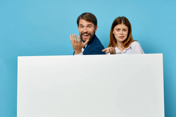 Alegre jovem casal funcionários apresentação papel branco cópia espaço publicidade — Fotografia de Stock