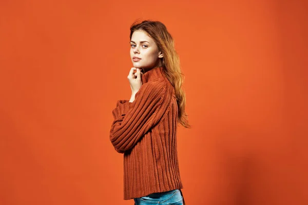 Red-haired woman in red sweater attractive look glamor studio fashionable clothes — Stock Photo, Image