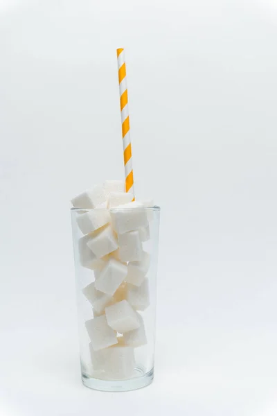 Sugar cubes in a glass with a tube high-calorie cocktail — Stock Photo, Image