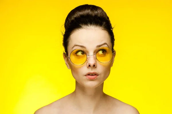 Woman with bare shoulders yellow glasses emotions — Stock Photo, Image