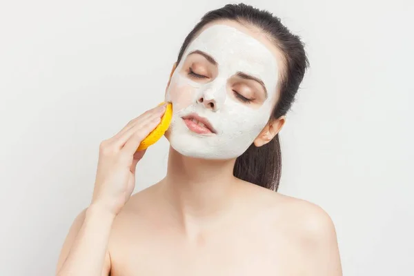 emotional woman with sponges in hands cream mask on face cropped view