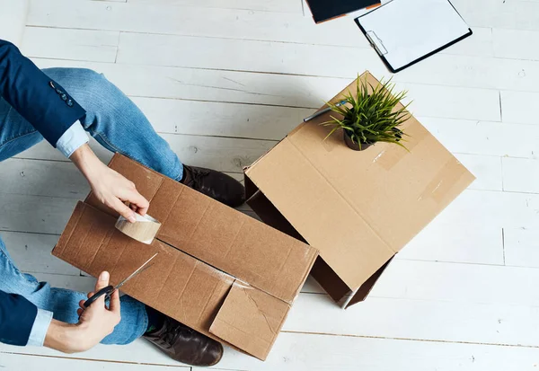 Man packing boxes moving office professional official