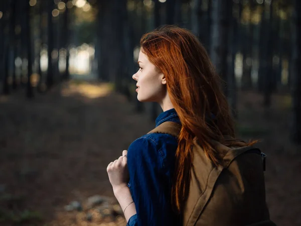 Šťastná cestovatelka s batohem na zádech odpočívá v přírodě v borovém lese — Stock fotografie