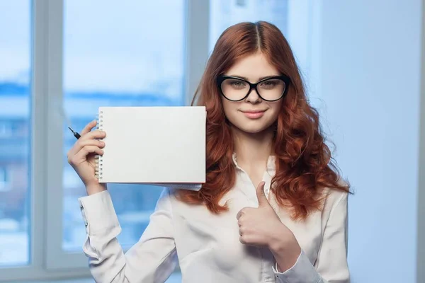 Руда жінка в окулярах з блокнотом в руках офіційний менеджер — стокове фото