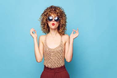 Çekici model kıvırcık saçlı, kırmızı dudaklı koyu renk gözlükler çekici görünüyor. 